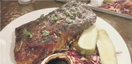  ?? ?? Half rack of ribs with house pickles, crunchy slaw and barbecue corn and pepper salsa.