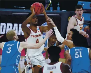  ?? PAUL SANCYA – THE ASSOCIATED PRESS ?? USC forward Evan Mobley, who scored 17 points, is fouled as he drives to the basket during the Trojans’ 72-56 victory against Drake in the NCAA Tournament West Region first-round game.