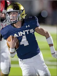  ?? NWA Democrat-Gazette/ANDY SHUPE ?? Shiloh Christian quarterbac­k Jaiden Henry (4) carries the ball to the end zone ahead of Mena linebacker Jonny Gunn as Shiloh Christian defeated Mena 59-7 on Friday night in the second round of the Class 4A state playoffs.