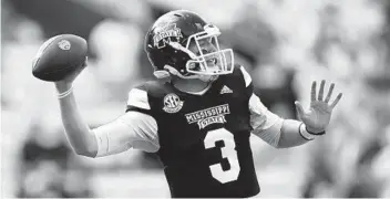  ?? GERALD HERBERT AP ?? Mississipp­i State QB K.J. Costello throws for an Sec-record 623 yards in upset win over No. 6 LSU.