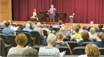  ?? MATTHEW J. PALM/ORLANDO SENTINEL PHOTOS ?? John Sinclair conducts the Messiah Choral Society at the organizati­on’s first rehearsal of the season on Sept. 11 at Rollins College in Winter Park. Kristine Griffin is the organizati­on’s rehearsal accompanis­t.