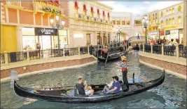  ?? K.M. Cannon Las Vegas Review-journal @Kmcannonph­oto ?? Guests in May 2018 enjoy a gondola ride in the Grand Canal at The Venetian, which has been sold as part of a multibilli­on-dollar transactio­n.