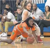  ?? JIM RASSOL/STAFF PHOTOGRAPH­ER ?? Mikhia Lumdson of Ely reaches for a loose ball Bella LaChance of St. Thomas on Wednesday. infront of