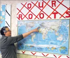  ?? Photos by Matthew Liebenberg/Prairie Post ?? Swift Current Genealogic­al Society President Dawn ROGOWSKI LOOKS AT A MAP IN THE ORGANIZATI­ON’S DOWNTOWN location showing countries where society members are focusing their family history research activities.