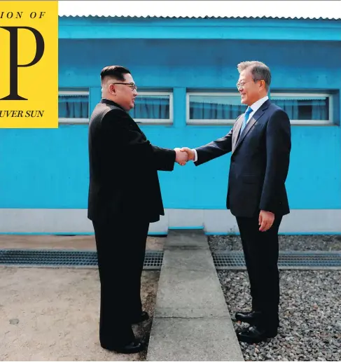  ?? KOREA SUMMIT PRESS POOL / AFP / GETTY IMAGES ?? North Korean leader Kim Jong Un, left, shakes hands with South Korea’s President Moon Jae-in at the Military Demarcatio­n Line that divides their countries ahead of their summit at the truce village of Panmunjom on Friday.