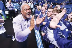  ?? Greensboro, N.C. (AP Photo/John Bazemore) ?? Kansas State head coach Jerome Tang celebrates with members of the pep band Sunday after defeating Kentucky in a second-round college basketball game in the NCAA Tournament in