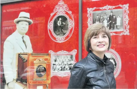  ?? NICK PROCAYLO ?? Chinese-Canadian Military Museum curator Catherine Clement stands in front of a display paying tribute to Yucho Chow at 50 E. Pender St. For four decades, Chow ran a photo studio known for portraits marked with a circular seal found in hundreds of old...