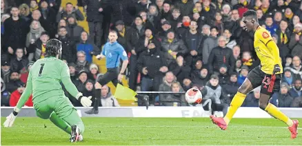  ?? AFP ?? Watford’s Ismaila Sarr scores his team’s second goal past Liverpool goalkeeper Alisson Becker at Vicarage Road.