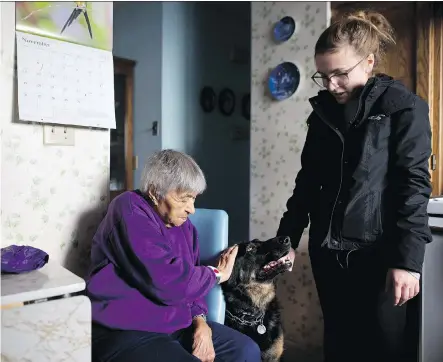  ?? LEAH HENNEL ?? Amy Anderson, 94, relies on volunteers from the Calgary Seniors Resource Society like Katie Oliver, 25, to help walk her dog Molly.