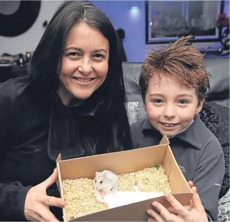  ??  ?? Valerie and Adam with “miracle” pet Hammy who survived an operation to remove a massive tumour.