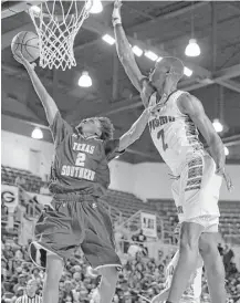  ?? Tim Warner ?? Texas Southern’s Derrick Bruce (2) goes up for a shot against Prairie View A&M’s J.D. Wallace in the first half of Friday night’s SWAC semifinal game.