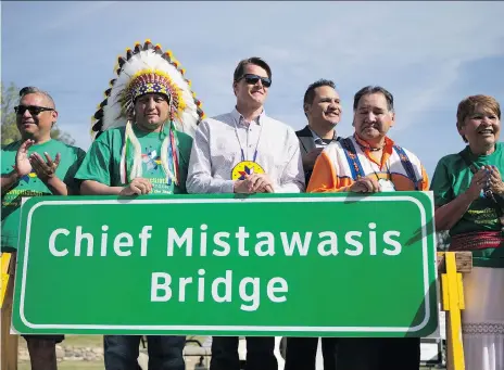  ?? KAYLE NEIS ?? FSIN vice-chief David Pratt, Saskatoon Tribal Council Chief Mark Arcand, Mayor Charlie Clark, Neal Kewistep, Gilbert Kewistep and Shirley Isbister reveal the new name for the north commuter bridge during a National Indigenous Peoples Day event on Thursday at Victoria Park.
