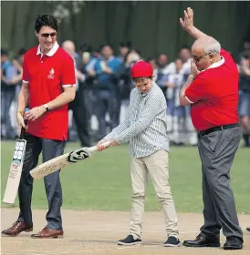  ?? MANISH SWARUP / THE ASSOCIATED PRESS ?? Prime Minister Justin Trudeau, left, watches his son Hadrien play cricket during the family’s visit to a school in New Delhi, India, on Thursday.