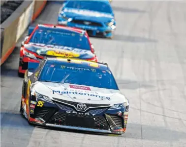  ?? AP PHOTO/WADE PAYNE ?? Matt DiBenedett­o leads the pack into a turn during Saturday night’s NASCAR Cup Series race at Bristol Motor Speedway.