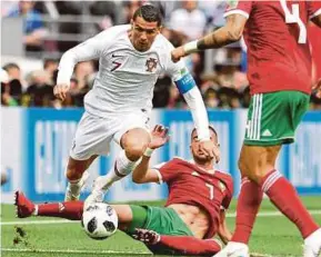  ?? EPA PIC ?? Portugal’s Cristiano Ronaldo (left) is tackled by Morocco’s Hakim Ziyach in a Group B match in Moscow yesterday.