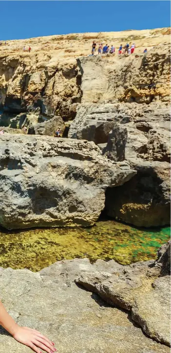  ??  ?? Sun bathing at Azure window, a famous tourist destinatio­n in Malta.