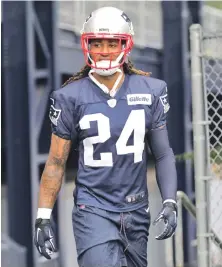  ?? STAFF PHOTO BY JOHN WILCOX ?? BACK TO WORK: New Patriots cornerback Stephon Gilmore, who signed as a free agent in the offseason, walks onto the practice field yesterday.