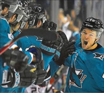  ?? GETTY IMAGES THEARON W. HENDERSON/ ?? The Sharks’ Tomas Hertl is congratula­ted by teammates after scoring a goal against the Ducks during the third period in Game 4 of the Western Conference first round Wednesday at SAP Center in San Jose, Calif.