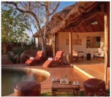  ??  ?? Everybody gets looked after: The master bedroom at Elsa’s Private House in Meru National Park, Sand River Masai Mara’s pool area, dinner al fresco African-style, and the giraffes with Mount Kilimanjar­o in the background.