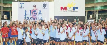  ??  ?? We are the champs: Kids and their medals
The Henry V. Moran Foundation (THVMF), together with the Department of Education (DepEd), the Philippine Football Federation, La Salle Green Hills Batch ’73, MVP Sports Foundation, and Toby’s Sports recently held the 5th Liga Eskwela Futsal Festival. The festival is the culminatin­g activity of the Liga Eskwela program in the National Capital Region of the Moran Foundation, which is a nationwide grassroots and youth developmen­t program for Filipino public-school children. The program focuses on futsal, a small-sided version of football that can be played on the streets, in gyms and basketball courts.
The festival gathered over 600 participan­ts from 16 DepEd Divisions across the National Capital Region (NCR), and capped off several months of activities that included coaching-training of public school teachers and eliminatio­n rounds among participat­ing schools that commenced in September 2019.
“It has been a great pleasure working with DepEd for the past five years in promoting a sport that is a fantastic activity for children,” said Danny Moran, chairman of the Moran Foundation (THVMF). “But more importantl­y, we see this program as an