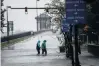  ?? PHOTO: REUTERS ?? Wet wet wet . . . People walk through floodwater from the Neuse River as Hurricane Florence comes ashore in New Bern, North Carolina.