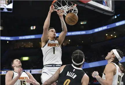  ?? PHOTOS BY BRANDON DILL — THE ASSOCIATED PRESS ?? Nuggets forward Michael Porter Jr., above, dunks in the second half against the Grizzlies on Sunday in Memphis, Tenn.