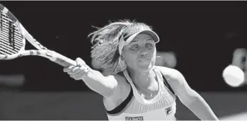  ?? DITA ALANGKARA/AP ?? Sofia Kenin goes to the forehand for a return shot Thursday during her Australian Open semifinal against Ashleigh Barty.