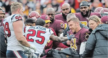  ?? MARK TENALLY THE ASSOCIATED PRESS ?? Houston Texans strong safety Kareem Jackson reaches for Washington Redskins quarterbac­k Alex Smith as he leaves the field after Jackson’s tackle caused Smith to suffer a badly broken leg.