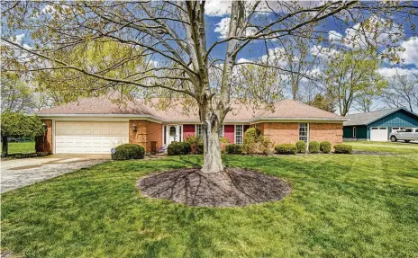  ?? CONTRIBUTE­D PHOTOS ?? The three-bedroom, brick ranch home offers about 2,090 sq. ft. of living space. The front of the home has a courtyard with brick-wall surround, mature trees and attached, two-car garage.