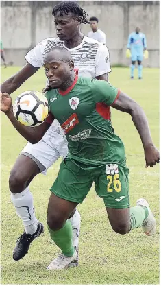  ??  ?? Humble Lion’s Michael Binns (right) is pressured for the ball by Chavaney Willis (left) of Portmore United during their Red Stripe Premier league match at the Spanish Town Prison Oval on Sunday, September 30.