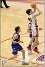  ?? MARK HUMPHREY ENTERPRISE-LEADER ?? Farmington sophomore Layne Taylor gets off a jump shot near the freethrow-line between two Harrison defenders. The Cardinals took on the Goblins in the 4A North Regional boys basketball tournament semifinal Sunday.