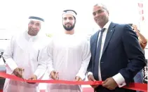  ??  ?? Anurag Agrawal, managing director, Canon Middle East, right, and Ammar Al-Malik, executive director of Dubai Internet City, center, during the opening of Canon’s Innovation Centre in Dubai.