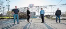  ?? JULIE JOCSAK TORSTAR ?? Mike Taylor of Youth Resources Niagara; Kate Flynn-scott, director of operations for Stolk Constructi­on;, Leonard Stolk, president of Stolk Constructi­on, and Aaron Kroeker, project manager of Stolk Constructi­on, in front of one of the two basketball nets they installed in Fonthill.