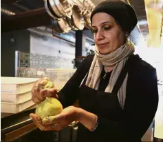  ??  ?? A taste of home: Anaee preparing khobz orouk, an Iraqi flatbread, at Tawla in San Francisco.