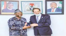  ??  ?? President of ANOCA, Mr. Mustapha Berraf (right) presenting the ANOCA Award to Nigeria’s Sports Minister, Mr. Sunday Dare in his office in Abuja...yesterday