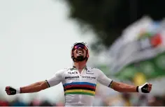  ?? Benoit Tessier, Pool photo via AP ?? France’s Julien Alaphilipp­e celebrates Saturday as he crosses the finish line of the first stage of the Tour de France cycling race over 122.9 miles with start in Brest and finish in Landerneau, France.