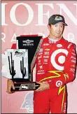 ??  ?? Scott Dixon of New Zealand, driver of the #9 Target Chip Ganassi Racing Chevrolet IndyCar poses with the winner’s trophy after winning the Phoenix Grand Prix at Phoenix Internatio­nal Raceway on April 2, in Avondale, Arizona.