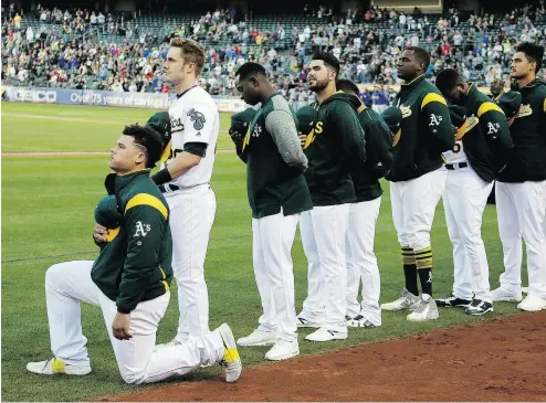  ?? ERIC RISBERG / THE ASSOCIATED PRESS FILES ?? Athletics catcher Bruce Maxwell kneels during the playing of the national anthem before the start of a game against the Texas Rangers in September 2017 in Oakland.