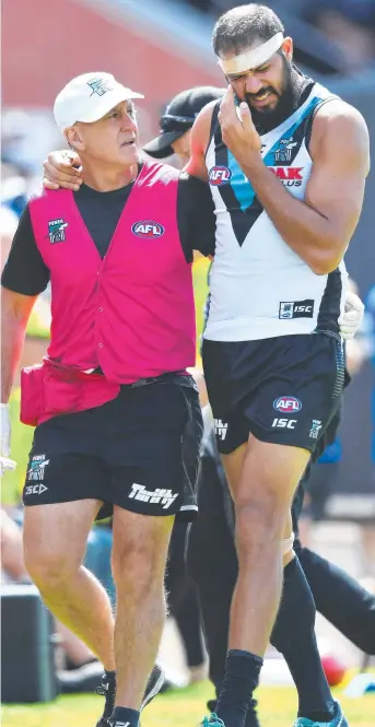  ?? Picture: GETTY/MARK BRAKE ?? Port Adelaide’s Paddy Ryder is helped from Alberton Oval during the last quarter of yesterday’s JLT Community Series match against North Melbourne