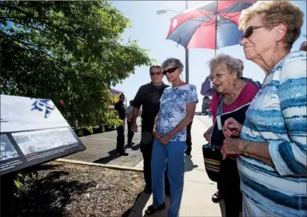  ??  ?? NICK HILLEMANN/TRILAKES EDITION Judy Creason, from the left, Patsy Searcy and Joyce Stoneciphe­r-Thornton look at the newly dedicated plaque commemorat­ing the 1913 Hot Springs fire with firefighte­r Shannon McDaniel.