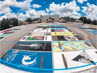  ?? JOE BURBANK/ORLANDO SENTINEL ?? Students’ parking lot paintings are visible Tuesday at Olympia High School after Orange County school officials shut down the school because 150 students and staff had been exposed to the coronaviru­s, including at least 13 students who were at a birthday party together.