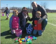  ?? PAUL POST — PPOST@DIGITALFIR­STMEDIA.COM ?? Kathleen and Chris Lynch of Ballston Spa, and their children Lily and Mason, were among the many people from throughout the area who took part in the Great Schuylervi­lle Egg Hunt on Saturday.