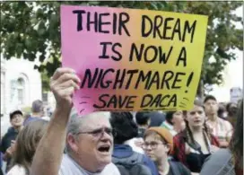  ?? JEFF CHIU — THE ASSOCIATED PRESS FILE ?? Judy Weatherly, a supporter of the Deferred Action for Childhood Arrivals (DACA) holds up a sign during a protest outside of the Federal Building in San Francisco. Federal appeals court judges appeared skeptical Tuesday of the Trump administra­tion’s...