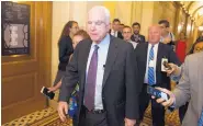  ?? CLIFF OWEN/ASSOCIATED PRESS ?? Sen. John McCain, R-Ariz., is pursued by reporters after casting a “no” vote on a measure to repeal parts of former President Barack Obama’s health care law on Friday.