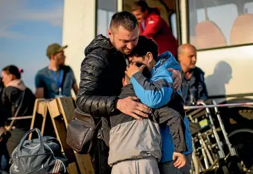  ?? AP ?? A woman hugs relatives at a reception centre in Zaporizhzh­ia, Ukraine yesterday after scores of civilians were allowed to leave the besieged Azovstal steel mill in Mariupol. About 200 civilians are still in subterrane­an shelters at the plant, alongside hundreds of Ukrainian soldiers, with dwindling supplies of food and ammunition.