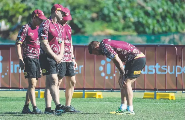  ?? Picture: PETER WALLIS ?? CAUSE FOR CONCERN: Queensland forward Josh McGuire went down midway through a Maroons training session at Sanctuary Cove yesterday.