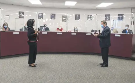  ?? JULIE DRAKE/VALLEY PRESS ?? State Sen. Scot Wilk (right) administer­s the oath of office Friday morning to newly elected Antelope Valley Community
College District trustee Michelle Harvey, Michael Rives also took the oath of office Friday.