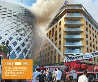  ?? AP ?? ICONIC BUILDING Civil defence personnel fighting the blaze in the landmark building in Beirut yesterday.