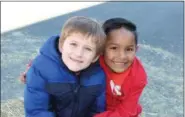  ??  ?? Franklin Elementary School students Leonardo Krasley and Paulo Moreira celebrate their friendship during the school’s recent fall festival.