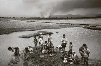  ?? Adam Dean / New York Times file photo ?? Fleeing burning villages they say were set ablaze by the military, Rohingya refugees rest near Palong Khali, Bangladesh, after crossing the border from Myanmar in September 2017.